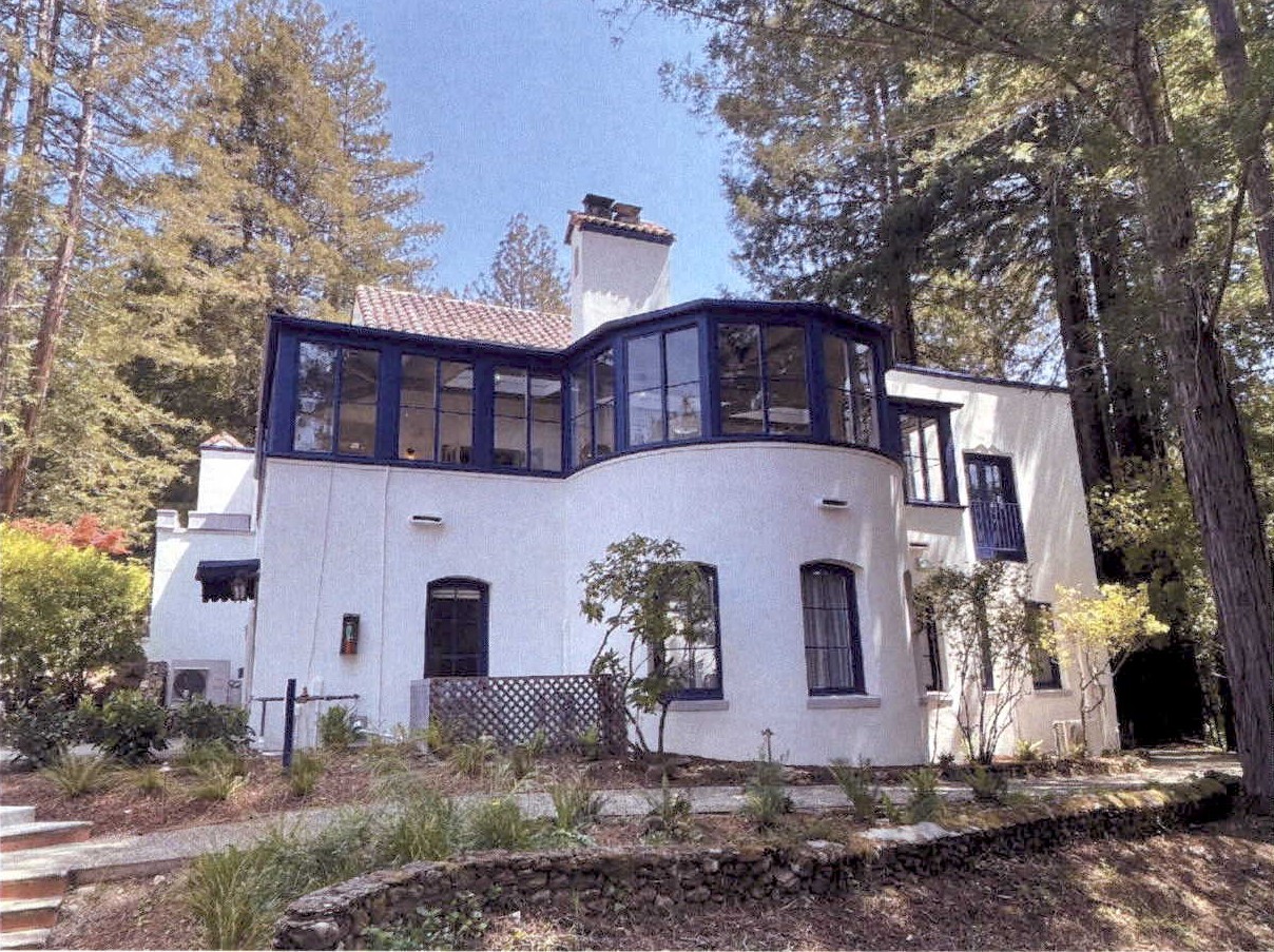 Restored west facade and river rock site wall